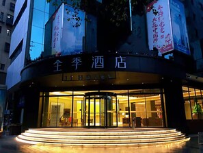 A hotel entrance with a revolving door and a sign reading "JI HOTEL". - Ji Hotel (Wuhan)