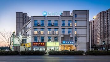 A multi-story hotel with a prominent sign, large windows, and a modern facade.