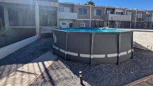A swimming pool with a surrounding deck, a building with multiple windows and balconies, and a clear sky. - Shoreline Condo 4 Desert Oasis Free Wifi Cool  AC (San Felipe)