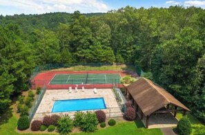 A tennis court with a pool and a pavilion surrounded by dense forest. - Creekside cabin, hot tub, fire pit, wood pizza oven n grill, dogs, near Ellijay (Ranger)