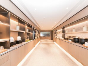 A modern, well-lit corridor with shelves on both sides displaying various kitchenware and appliances. - Ji Hotel (Zhengzhou)