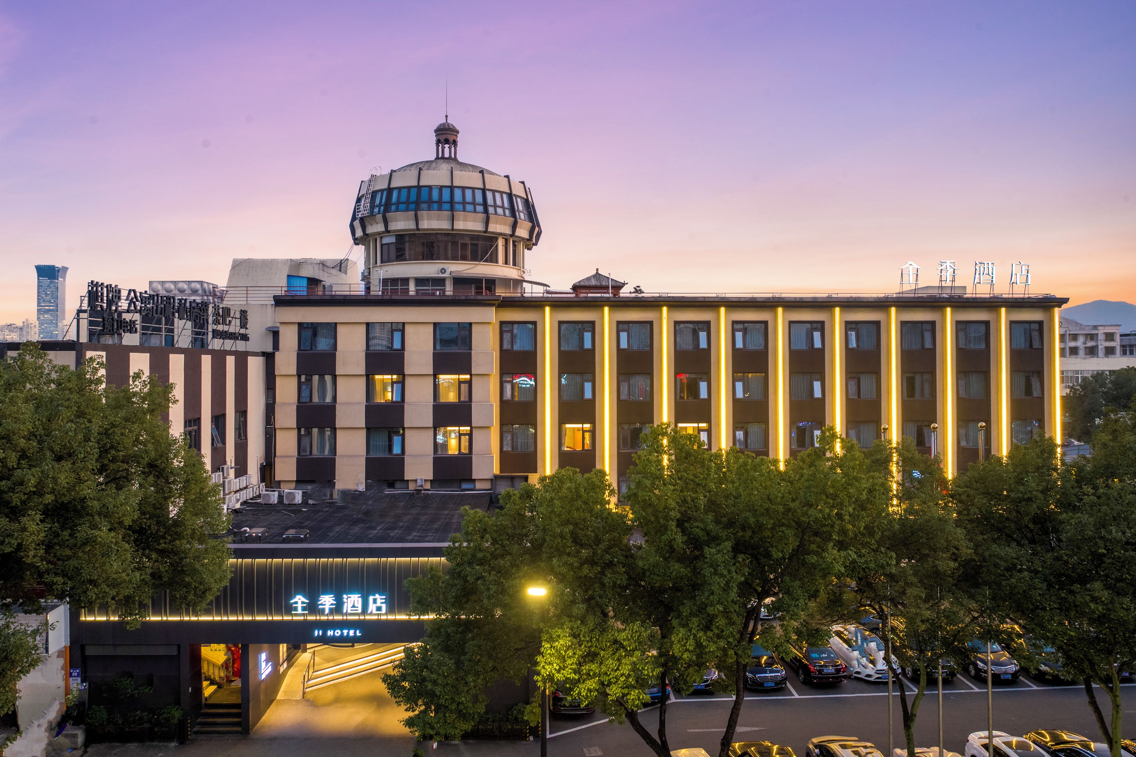 A hotel with a prominent dome structure, multiple floors, and a well-lit entrance.