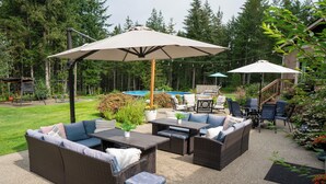 An outdoor patio with wicker furniture, a pool, and a wooden deck. - Large private retreat (Union)