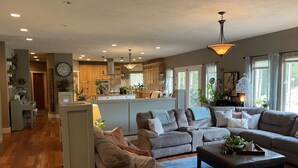 A spacious living room with a large sectional sofa, a coffee table, and a kitchen in the background. - Large private retreat (Union)