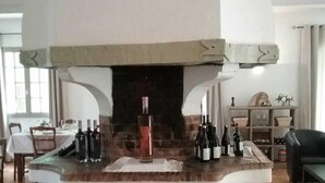 A kitchen with a central island, a built-in oven, and a wine rack. - Human Hotel Résidence  (Villecroze)