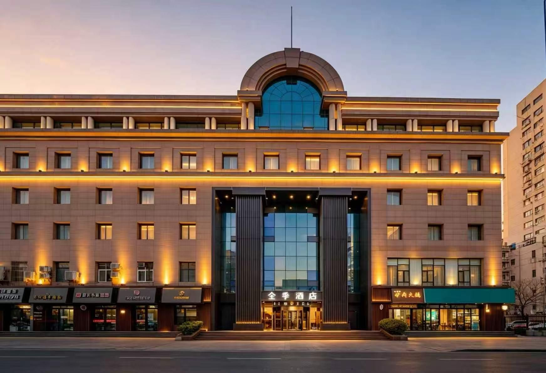 A hotel with a prominent entrance, multiple floors, and a modern architectural design.