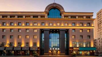 A hotel with a prominent entrance, multiple floors, and a modern architectural design.