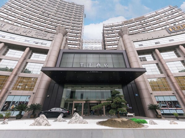 A modern hotel with a prominent entrance, large windows, and a symmetrical facade. - JI Hotel (Hangzhou)