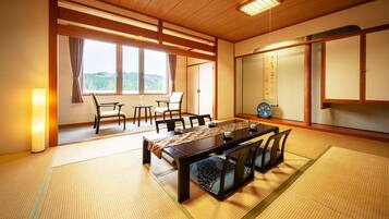 A traditional Japanese-style room with tatami flooring, a low wooden table, and shoji screens.
