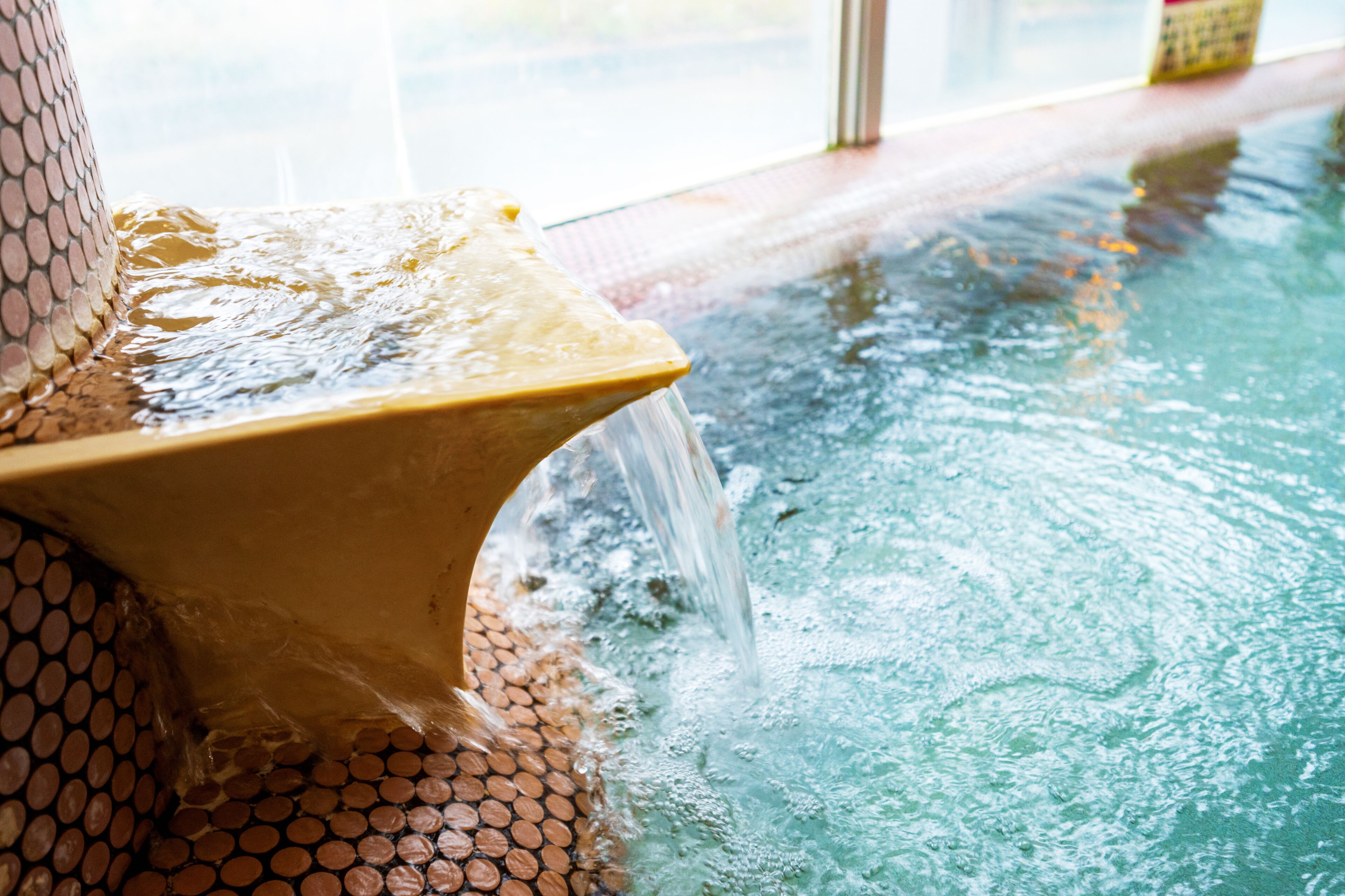 A water feature with a tiled base and a curved structure.