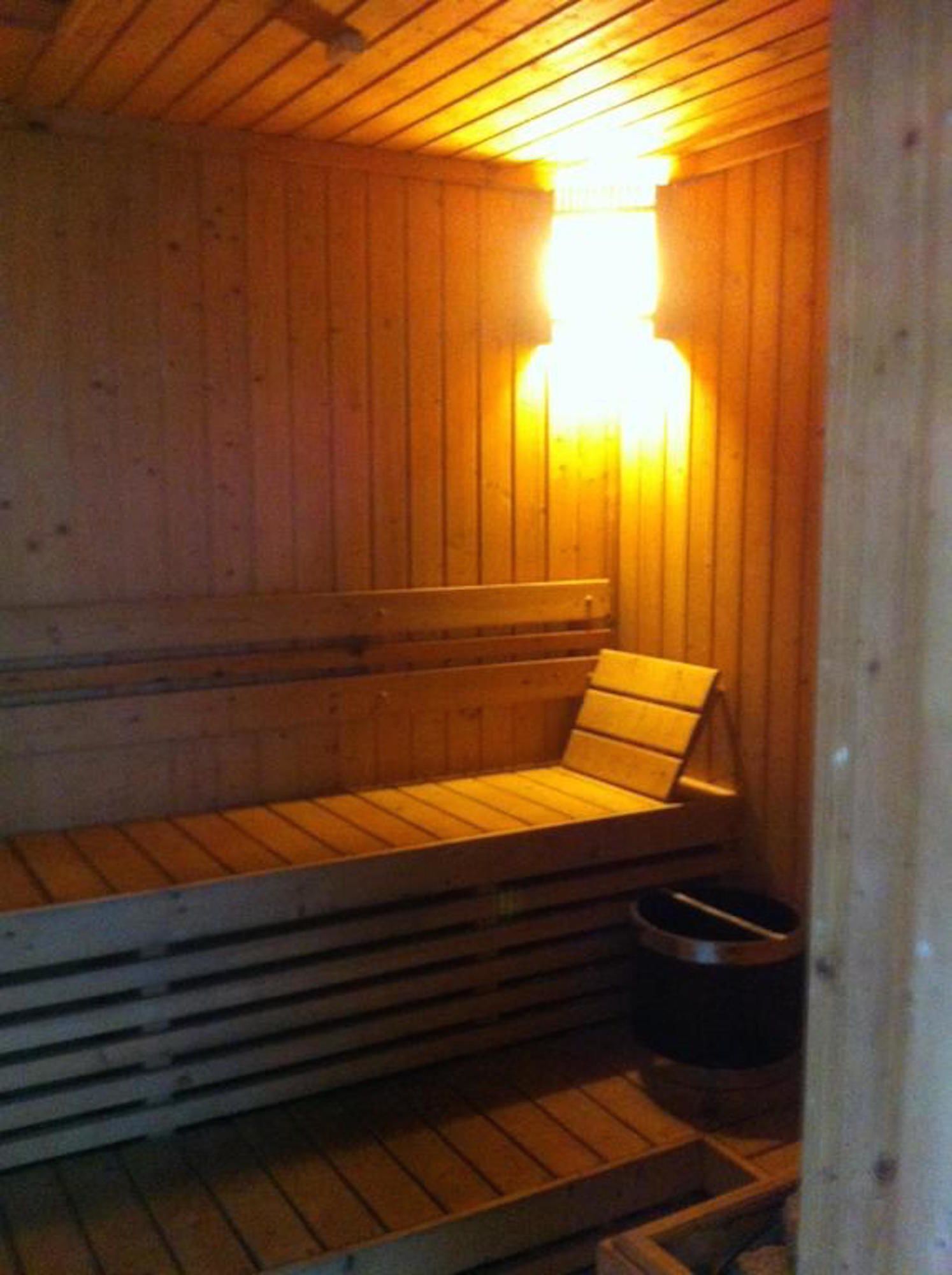 A sauna with wooden benches and a bench seat, a bench seat, and a bench seat.