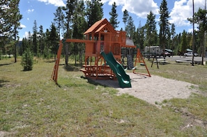 Explore the great outdoors with a fun play structure featuring a slide and platform with ladder.