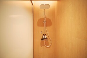 A shower with a handheld showerhead and a wall-mounted control panel. - Ji Hotel (Beijing)