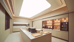 A modern kitchen with a central island, built-in appliances, and a large skylight. - Ji Hotel (Beijing)