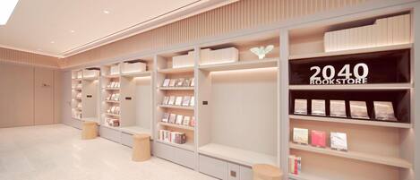 A modern bookstore interior with white shelving, books, and a '2040 BOOKSTORE' sign.