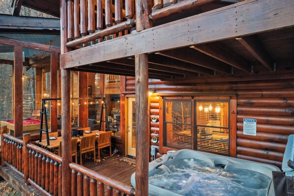 Relax in a cozy cabin with a spacious deck, pool table, and hot tub.