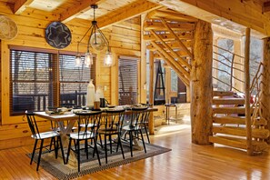 Enjoy meals in this charming dining area with a large round table and comfortable seating.