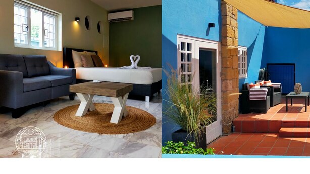 A modern interior with a sofa, a bed, and a coffee table. - Studio (Willemstad)