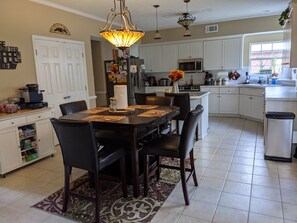 Enjoy cooking and dining in this well-equipped kitchen with ample workspace and seating for four.