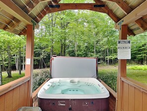 A hot tub under a wooden pavilion surrounded by trees. - Beautiful Adventure by Taylor Made Deep Creek (Swanton)