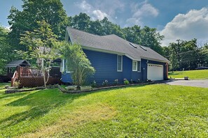 A single-story house with a garage, a small porch, and a well-maintained lawn. - Beautiful Adventure by Taylor Made Deep Creek (Swanton)