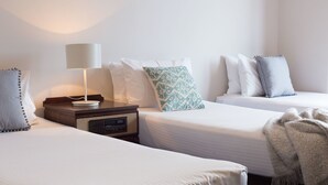 A hotel room with two single beds, a bedside table with a lamp, and a radio. - Coogee Bay Hotel Pub Style (Sydney)