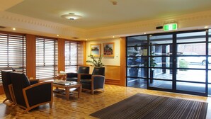 A hotel lobby with wooden flooring, a reception desk, and seating area. - Coogee Bay Hotel Pub Style (Sydney)
