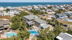 A residential area with houses, a swimming pool, and a view of the ocean. - Oceans 20 | 480 ft. to the beach | Private Pool, Hot Tub (Virginia Beach)
