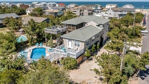 A large house with a swimming pool, multiple decks, and a view of the ocean. - Oceans 20 | 480 ft. to the beach | Private Pool, Hot Tub (Virginia Beach)