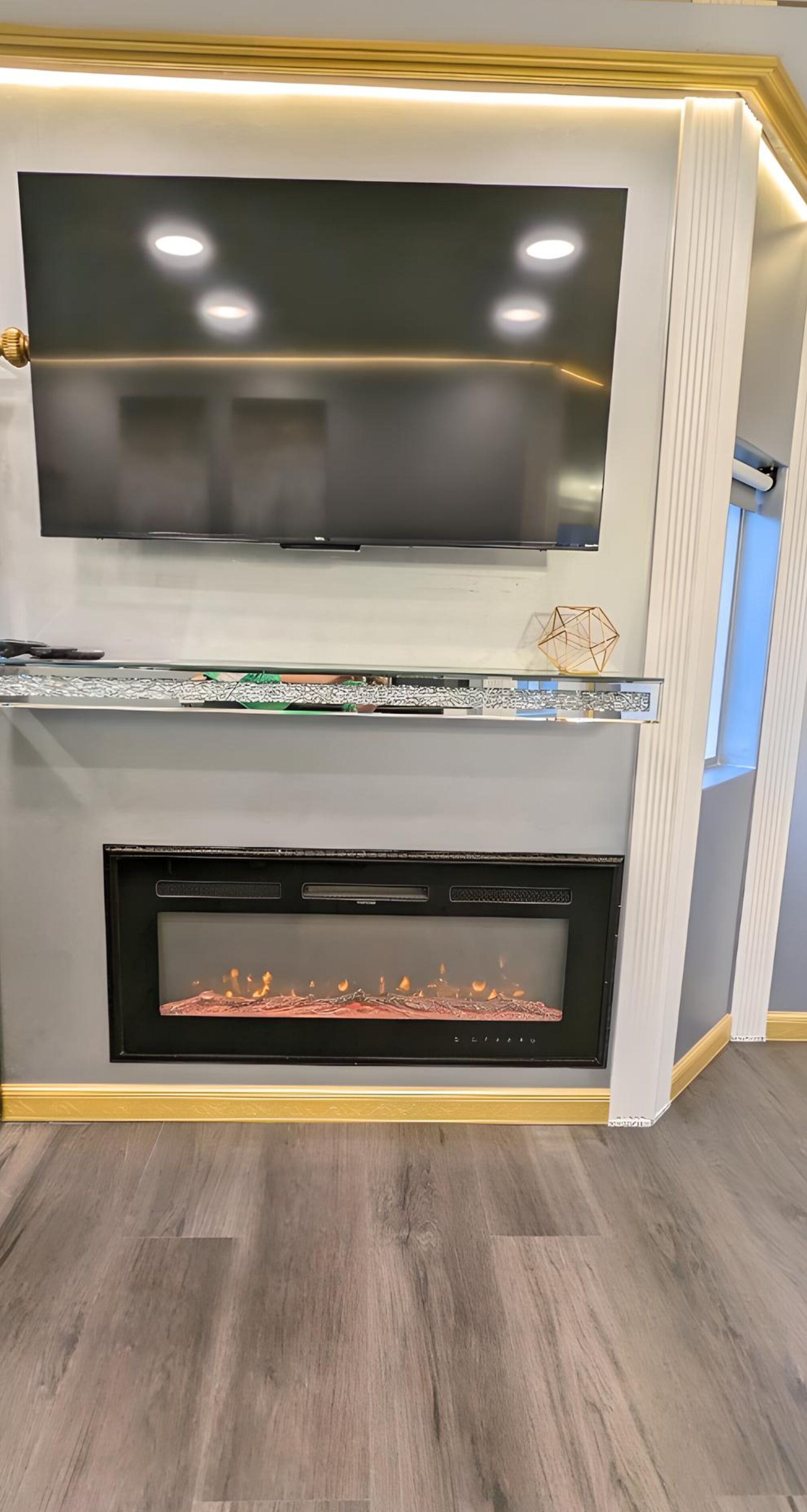 A modern living room with a flat-screen TV mounted above a fireplace.