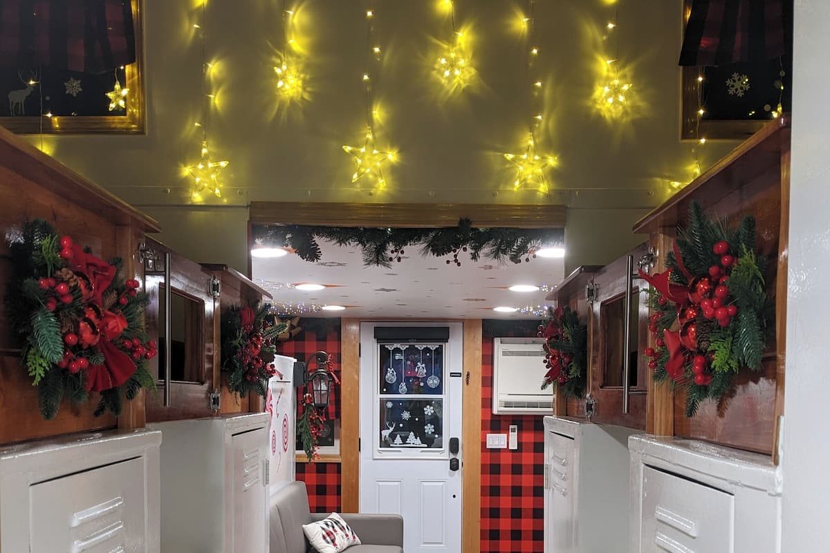 A hallway with lockers, a sofa, and Christmas decorations.