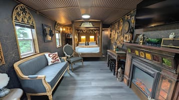 Luxury Studio, 2 Queen Beds (Wizard's Whistlestop - Private Caboose) | Living area | 32-inch TV with cable channels