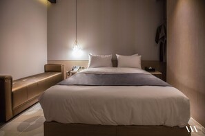 A modern hotel room with a large bed, a bedside table with a phone, and a hanging light fixture. - Hound Hotel Seomyeon-bumcheon (Busan)