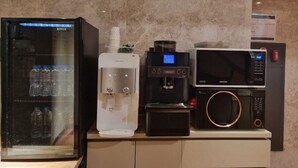 A self-service beverage station with a water dispenser, coffee machine, and microwave. - Hound Hotel Seomyeon-bumcheon (Busan)