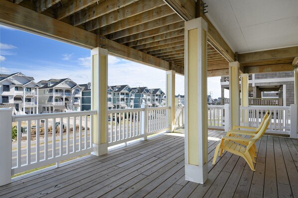 Relax on the covered outdoor deck with a comfortable chair and take in the views of the surrounding buildings.
