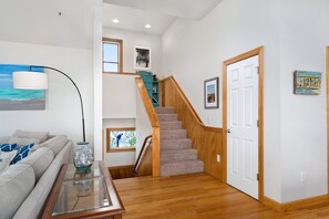A staircase with wooden railings and carpeted steps leading to a door.
