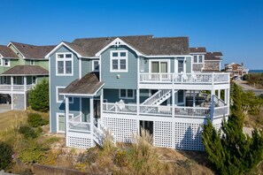A two-story house with a balcony and a front porch.