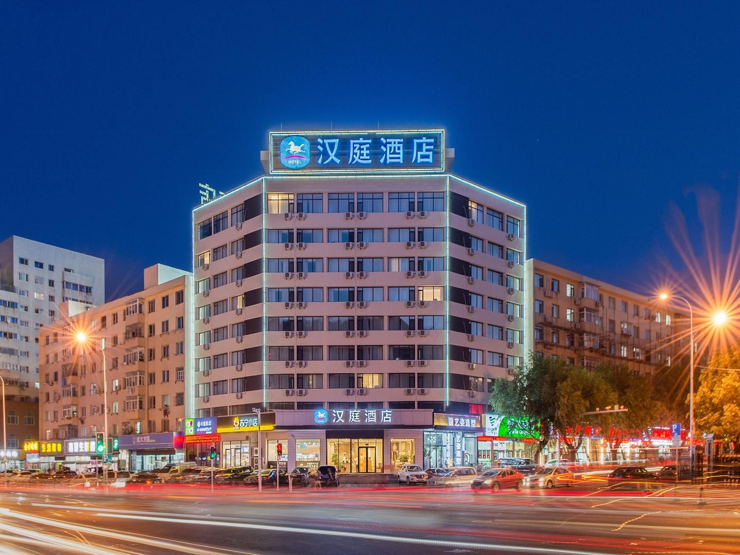A multi-story hotel with a prominent sign at the top.
