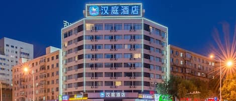 A multi-story hotel with a prominent sign at the top.