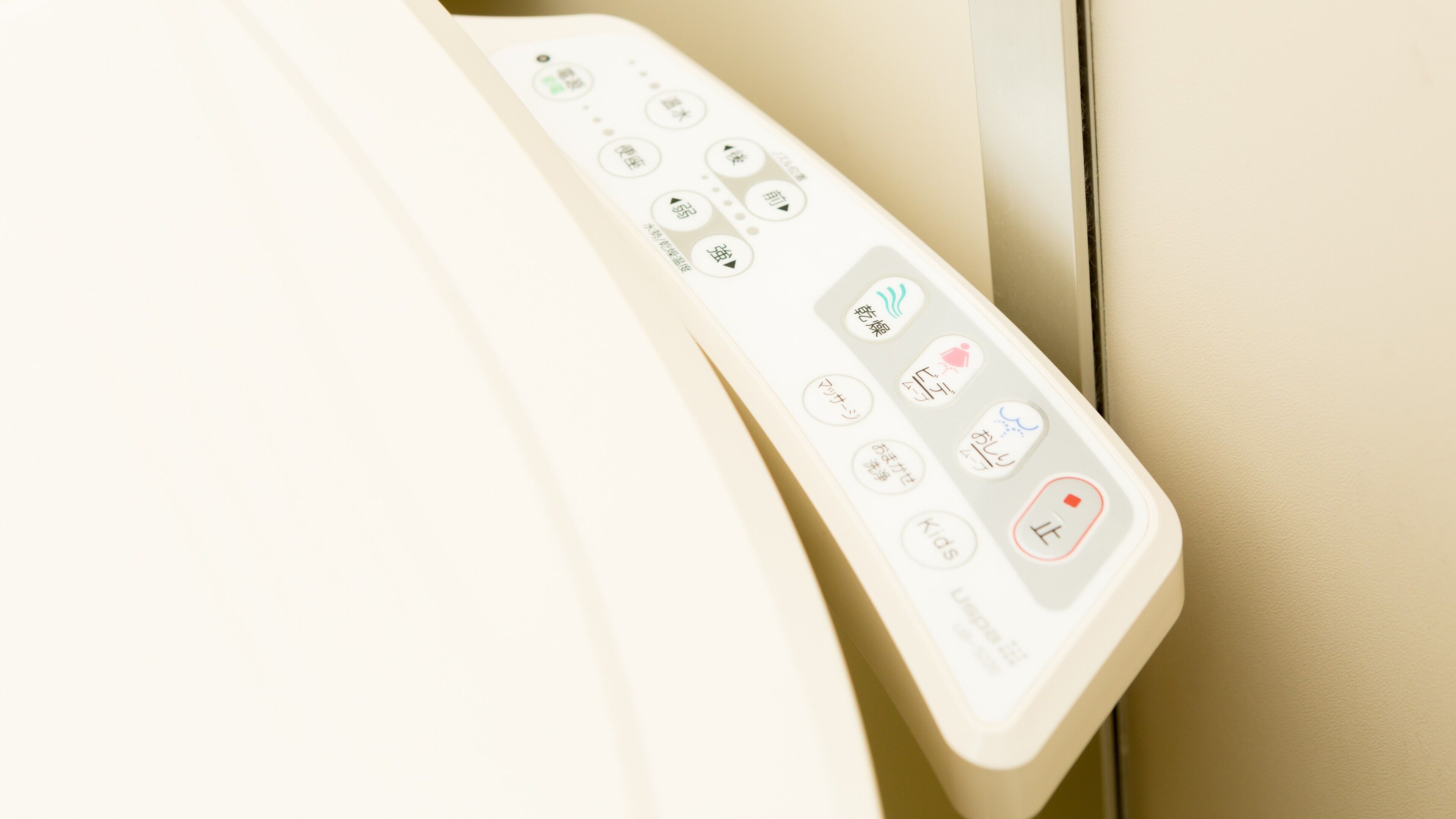 A control panel with various buttons, including a power button, a menu button, and a button with a red dot indicating a specific function.