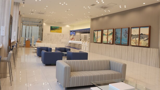 A modern lobby with a reception desk, seating area, and artwork on the walls. - Toyoko Inn Fujisan Otsuki-eki (Otsuki)