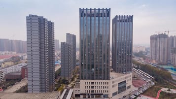 A high-rise building with multiple floors, surrounded by other tall buildings, indicating a dense urban area.