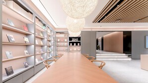 Una biblioteca moderna con una larga mesa de madera, estanterías y un letrero que dice '2040 BOOKSTORE'.