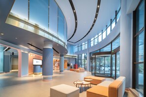 A spacious lobby with high ceilings, large windows, and modern seating areas. - Hanting Hotel (Zhengzhou)