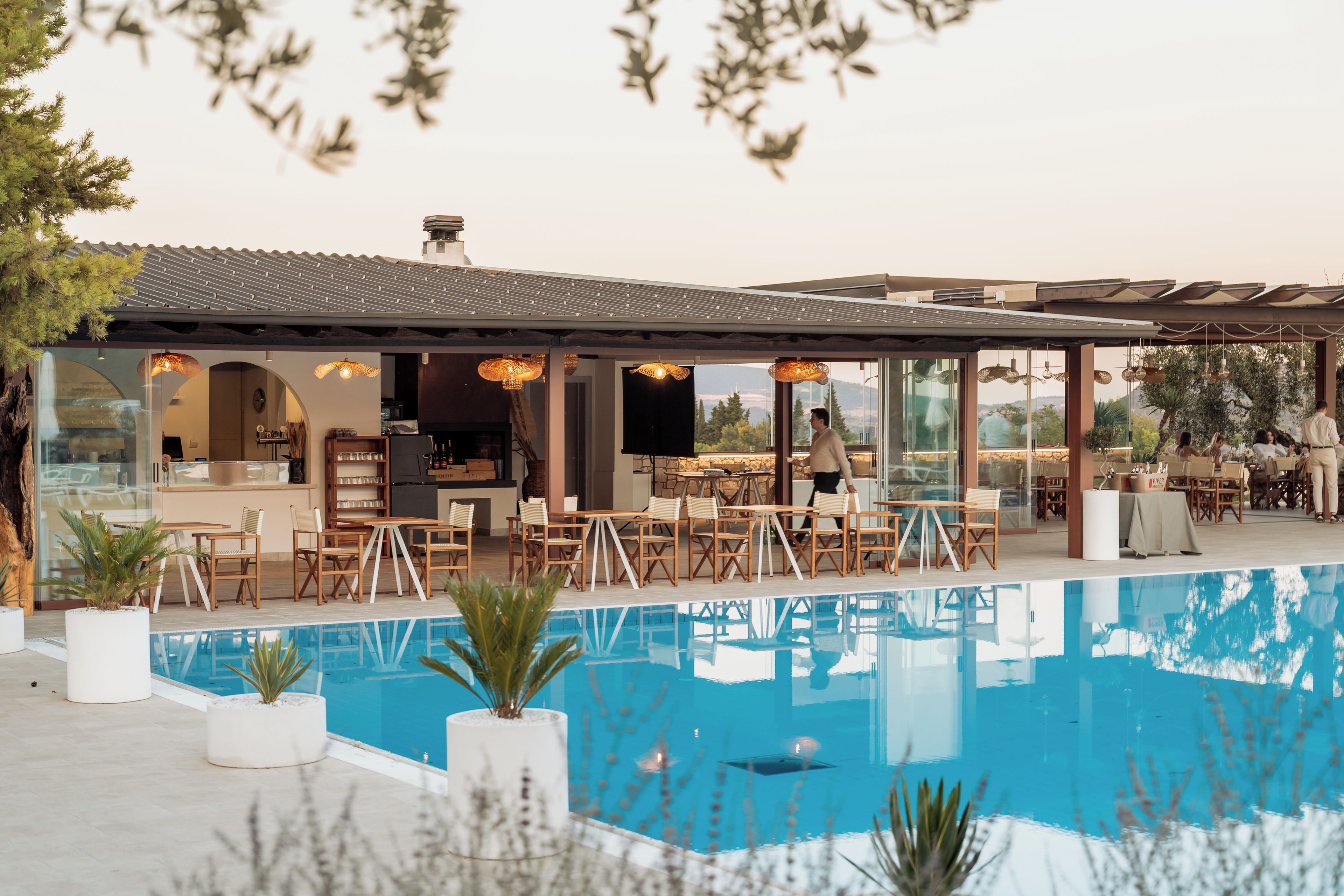 A poolside area with outdoor seating and a view of the pool.