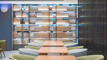 A modern library with rows of bookshelves, seating areas, and a contemporary design.