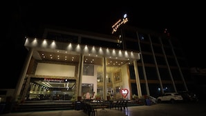 A hotel with a prominent sign reading "The Grand Astoria." - The Grand Astoria Somnath (Veraval)
