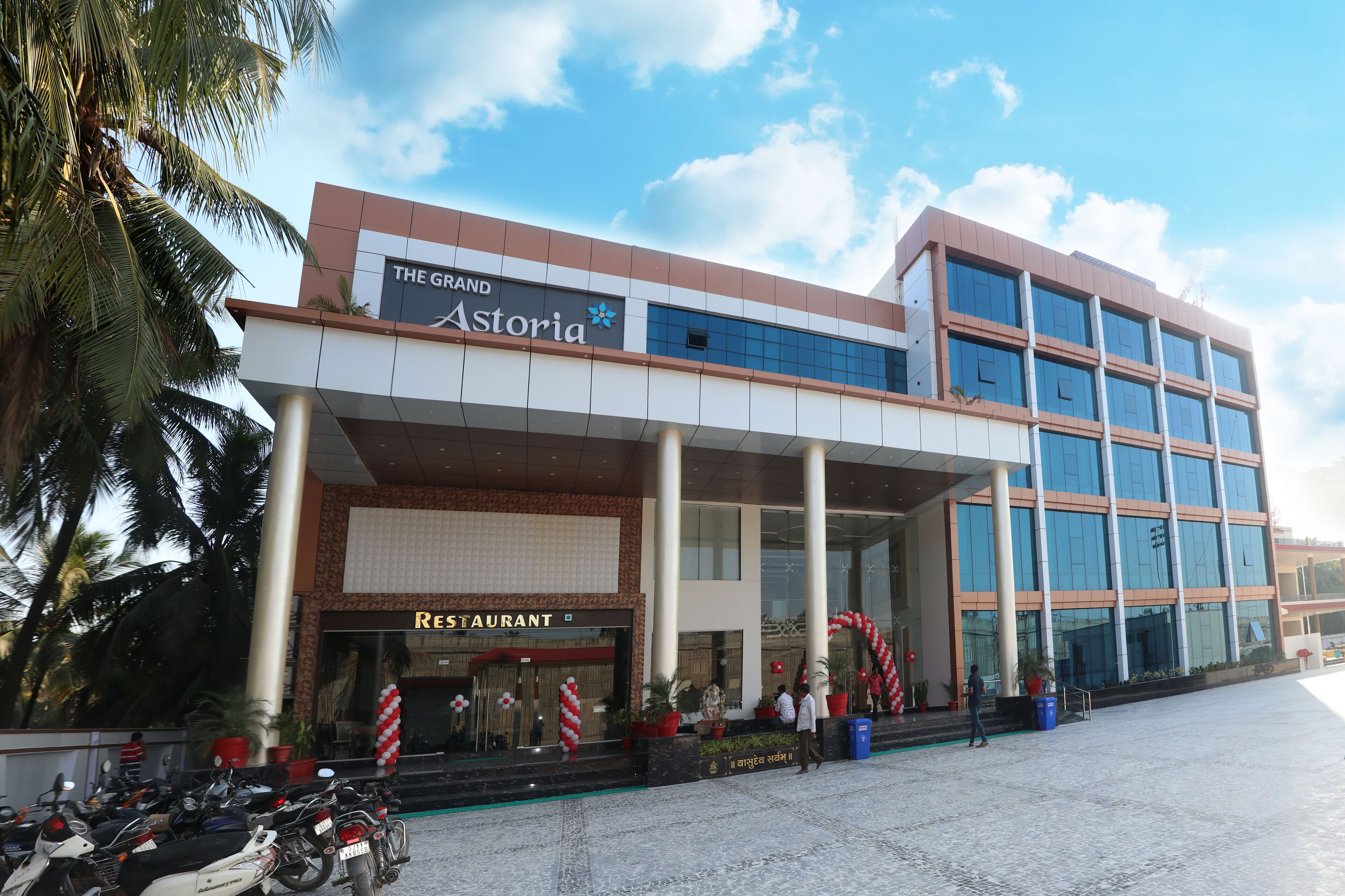 A hotel with a restaurant named 'The Grand Astoria' and a modern building with large windows.
