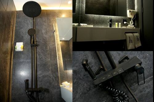 Een douche, een regendouche, designer toiletartikelen, een haardroger