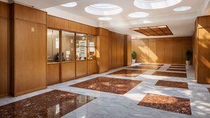 A hallway with wooden paneling, a marble floor, and skylights. - AR ROOMS ROME   blue room superior (ROMA)